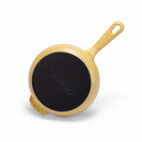 Yellow enameled cast iron skillet by BUCHYMIX NIGERIA, with a sturdy handle and smooth, vibrant yellow cooking surface.